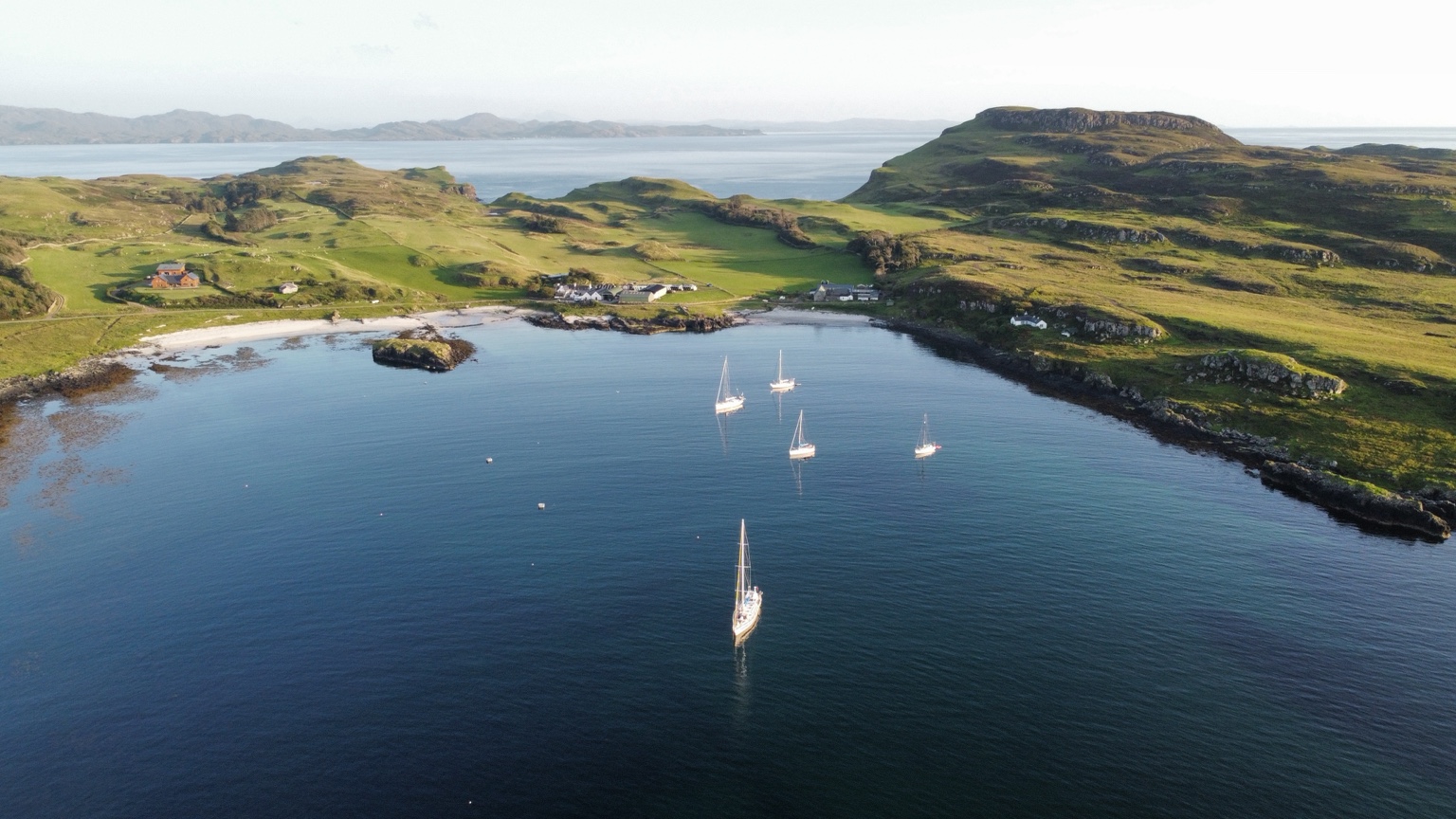 Aerial view of yachts in a dramatic island bay