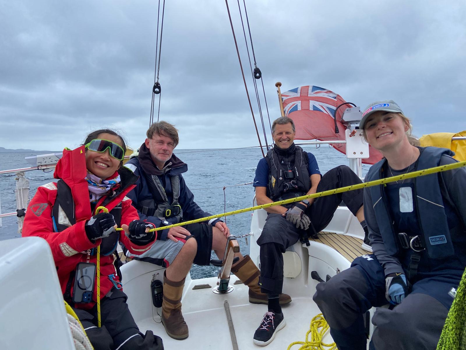 Four smiling crew members aboard Nimrod