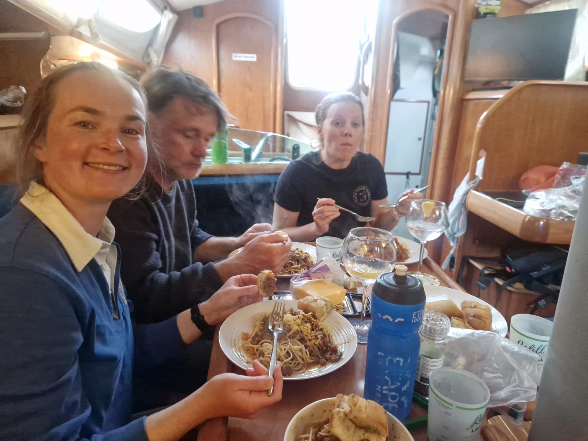 Crew sharing a meal around Nimrod's saloon table